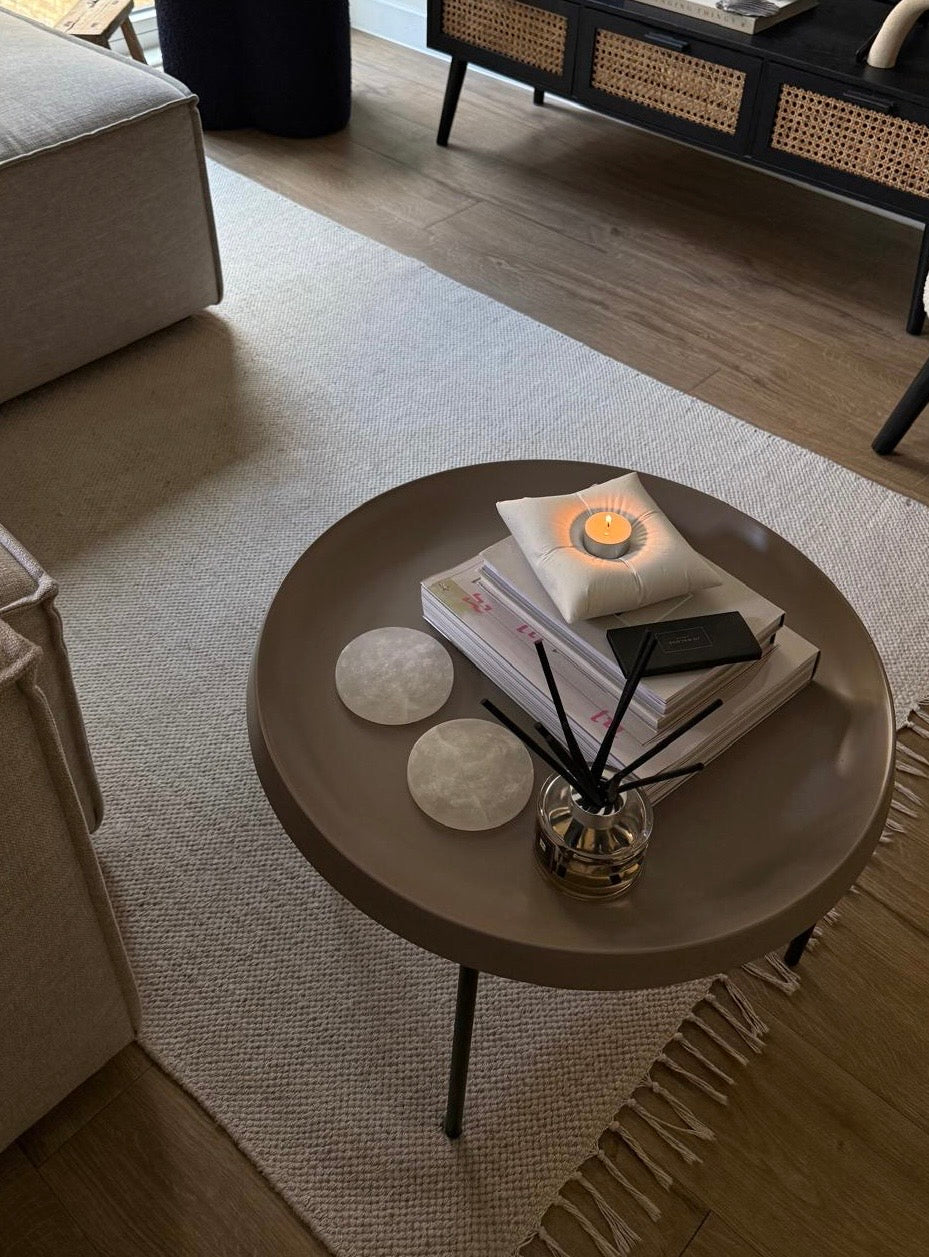 Sculptural pillow shaped candle on a coffee table setting